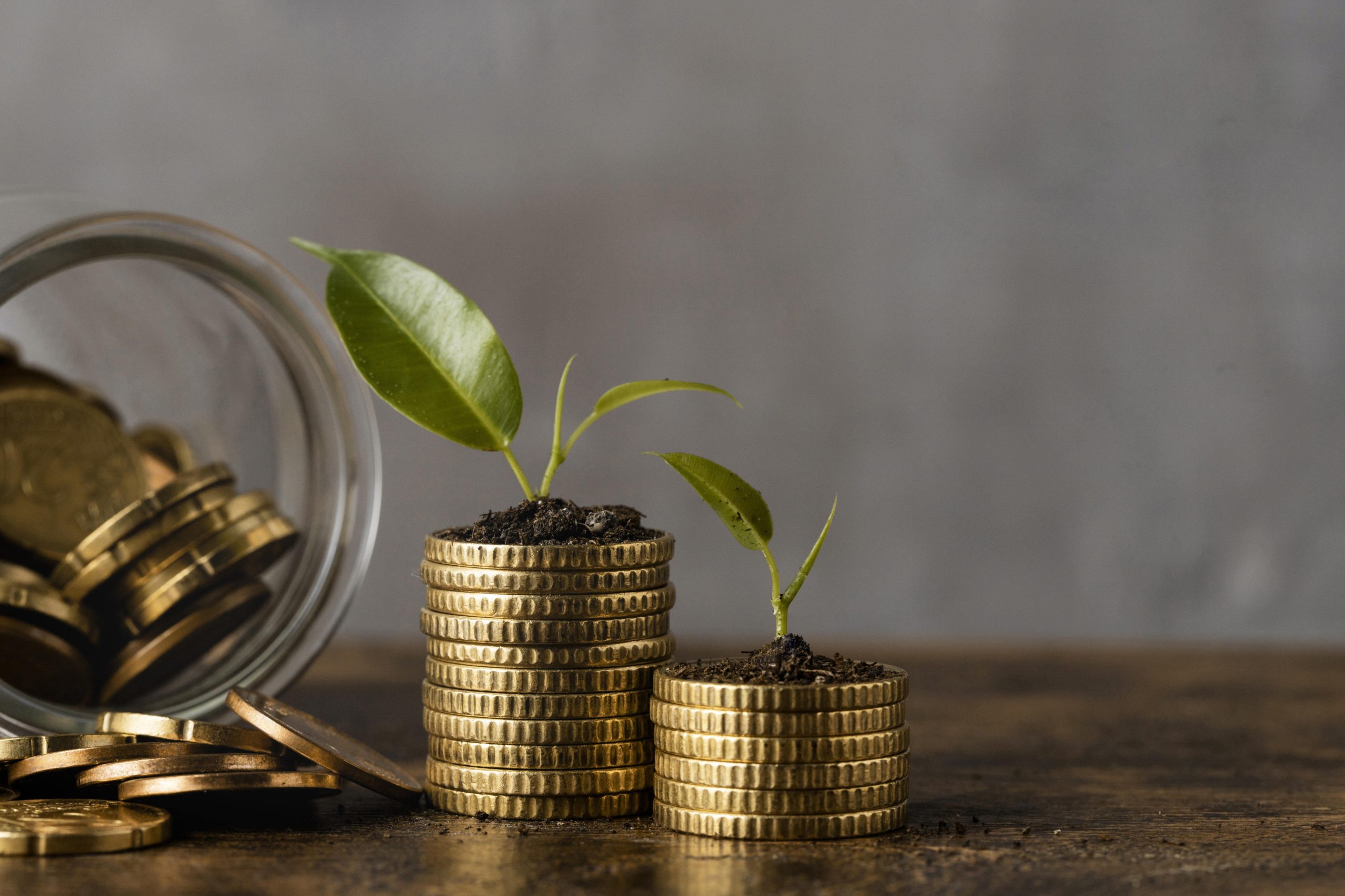 Coins spilling out of a jar and two piles of coins with seedlings sprouting out of the top.