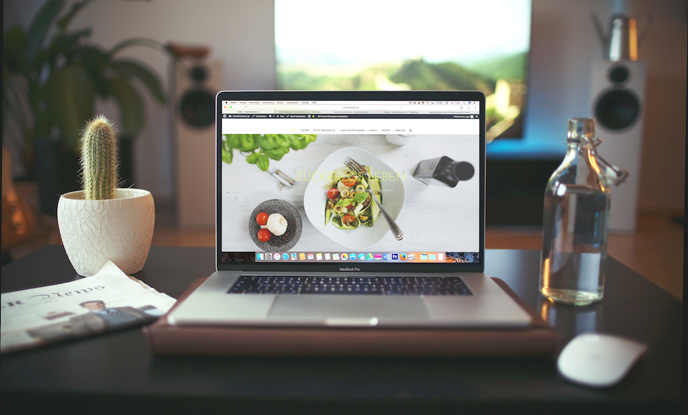 laptop on desk with image of food on screen